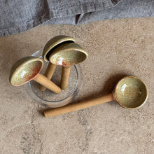 Load image into Gallery viewer, Set of ceramic spoons on a concrete surface with a gray garment in the background
